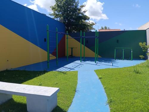 a playground with a bench next to a building at Loft Noruega 32 AC Garagem Privativa in Jaguarão