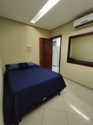 a bedroom with a blue bed in a room at Suíte Nazaré in Belém