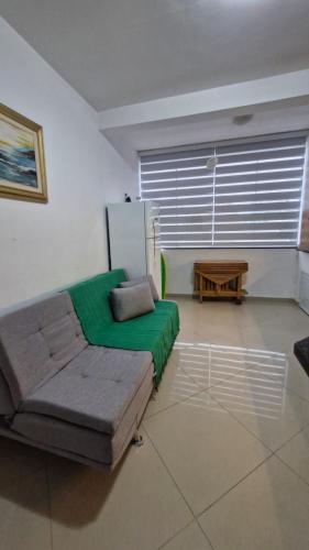 a living room with a couch and a table at Caioba com excelente localização in Matinhos