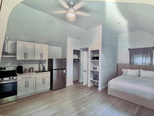 a living room with a bed and a kitchen at Wainscott Woods Retreat in Wainscott