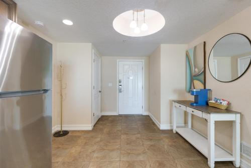 a hallway with a mirror and a table at 3BR Luxury Penthouse Panoramic Views in St Pete Beach