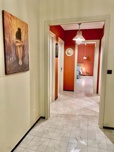 a hallway with a painting of a woman on the wall at moroccan style apartment 10 min from the Marina and beach of Tangier in Tangier