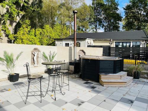 a patio with a table and chairs in front of a house at 4 person holiday home in SÖLVESBORG in Hällevik