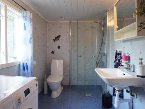 a bathroom with a toilet and a sink and a shower at 6 person holiday home in LYSEKIL in Torgestad