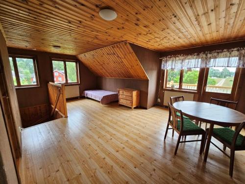 a room with a table and chairs in a room at 8 person holiday home in Ryssby in Ryssby