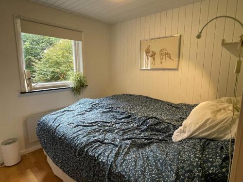 a bedroom with a bed and a window at 9 person holiday home in SÖSDALA in Bjärnhult