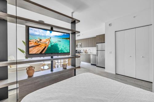a living room with a large tv on a wall at Luxury High-Rise Condo in Downtown Miami - Pool and Gym in Miami