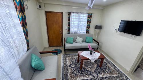 a living room with a couch and a table at Rai-Ki-Wai Accomodation in Suva