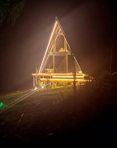 a cabin at night with lights on the side at Cabana Refúgio Barn in Caxias do Sul