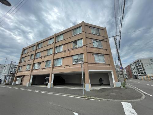 a tall building on the corner of a street at テラ二十四軒 in Sapporo