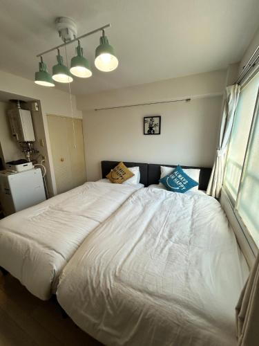 a bedroom with a large bed with two pillows on it at テラ二十四軒 in Sapporo