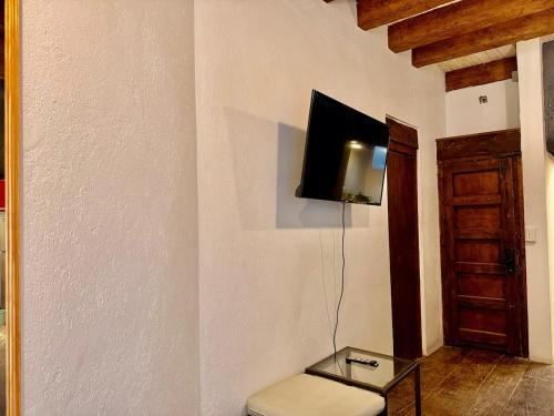 a living room with a tv on a wall at Tizapan 04 NEW 1BE&1BA in Mexico City