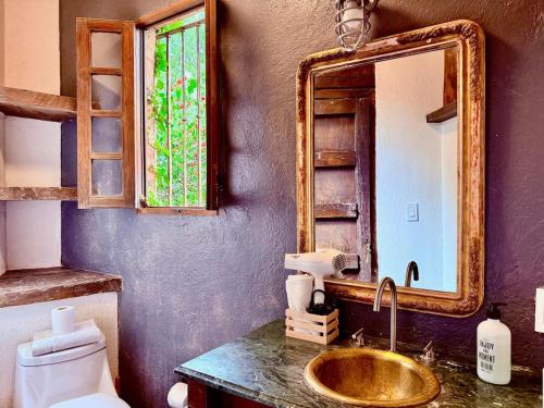 a bathroom with a gold sink and a mirror at Tizapan 04 NEW 1BE&1BA in Mexico City