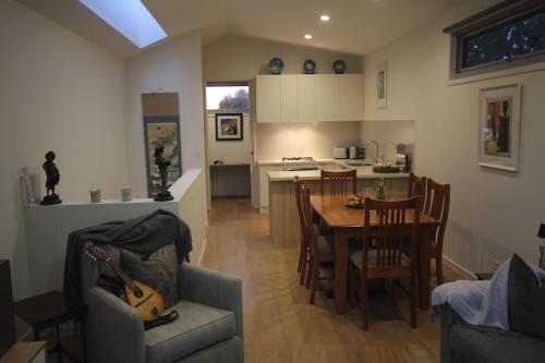 a kitchen and dining room with a table and chairs at Lily's Townhouse in Melbourne