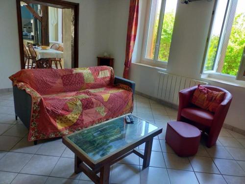 a living room with a couch and a coffee table at Maison avec cour, WiFi, animaux admis, parking - Saint-Rimay - FR-1-491-383 in Saint-Rimay