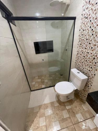 a bathroom with a toilet and a shower at Private pool, spacious, barbecue in Londrina