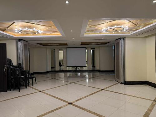 a large room with a screen and a podium in it at Venice Vista Lodge Staycation near Venice Grand Canal in Manila