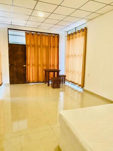 an empty room with a table and a table at The Castle Safari Cottage in Udawalawe