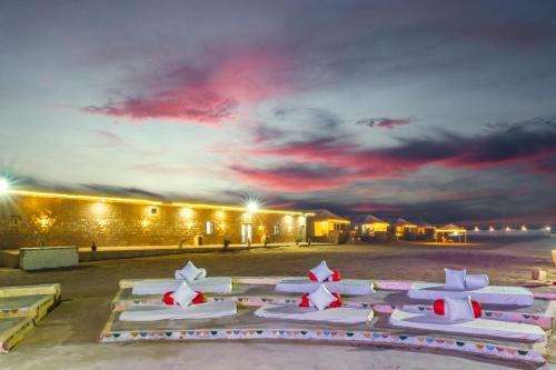 a group of white chairs with red and white stars at Desert Island Camp & Resort Jaisalmer in Jaisalmer
