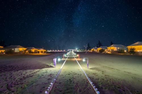 a starry night with a track in the sand at Desert Island Camp & Resort Jaisalmer in Jaisalmer