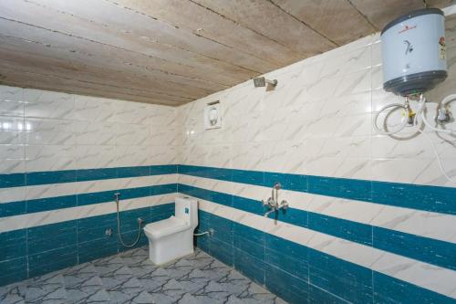 a bathroom with a toilet with blue and white stripes at Desert Island Camp & Resort Jaisalmer in Jaisalmer