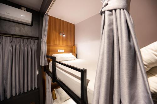a small room with two bunk beds in it at Pokhara Backpackers Hostel in Pokhara