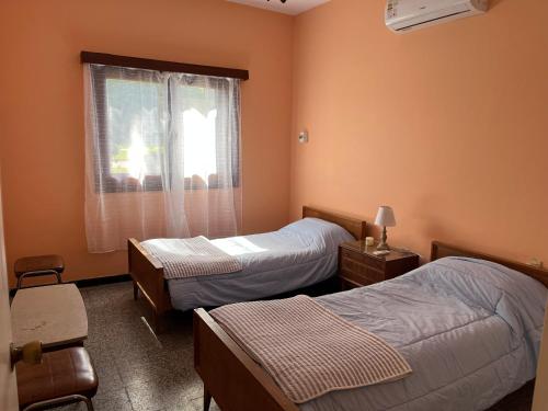 a hotel room with two beds and a window at Corbeta in Piriápolis