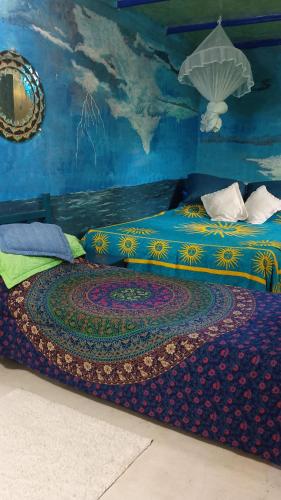 a bedroom with a large bed with a rug on it at Estância Verde in Valença