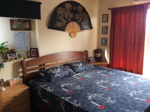 a bedroom with a bed with a blue comforter at Great Value Residence in Bangna