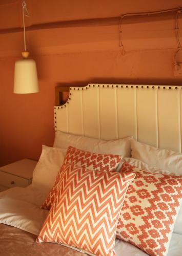 a bed with a white headboard and two pillows at Goodnight hotel in the ancient Hutong in Beijing
