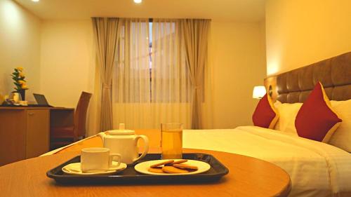 a tray of food on a table in a hotel room at The Continental Near Mg Marg in Gangtok