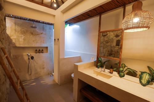 a bathroom with a shower and a sink at Muzeum Villas II Bingin in Bingin Beach