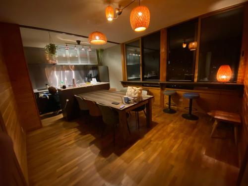 a dining room with a table and a couch at 月灯草津 in Wada