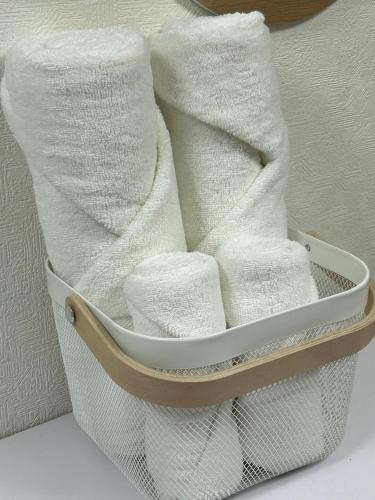 a basket filled with white towels on a table at COMMA House in Yokohama