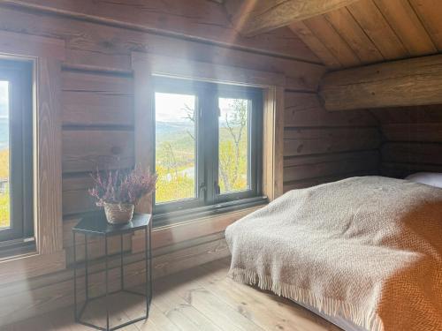 a bedroom with a bed and two windows at Modern Family Cabin Near Kikut In Geilo in Flatåker