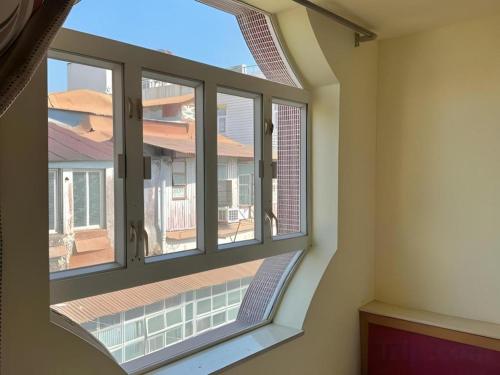 an open window with a view of a building at Man Va Hotel in Macau