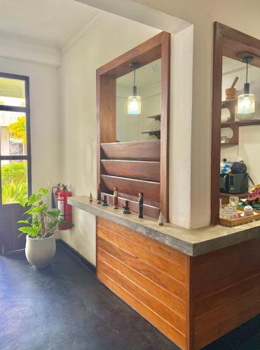 a bathroom with a mirror and a sink at Jess Beach Villa in Galle