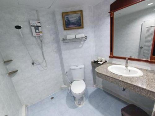 a bathroom with a toilet and a sink and a shower at New Siya in Maha Sarakham