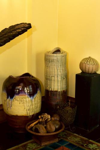 a group of vases and bowls on a table at CS Pattani Hotel in Ban Ru Sa Mi Lae