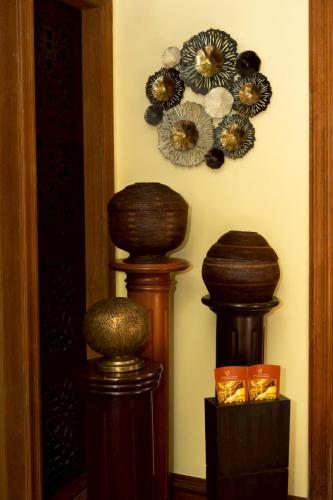a room with two wooden vases on a wall at CS Pattani Hotel in Ban Ru Sa Mi Lae