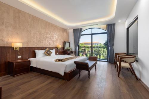 a bedroom with a bed and a large window at Tam Coc Orchid Hotel & Spa in Ninh Binh