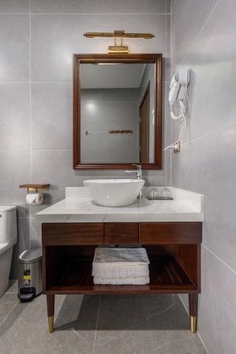 a bathroom with a sink and a mirror at Tam Coc Orchid Hotel & Spa in Ninh Binh