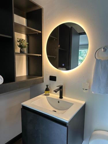 a bathroom with a sink and a mirror at Cabaña Yará in Dosquebradas