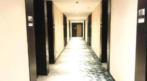 a hallway of a building with a long corridor at GreenTree Inn Express Yingtan Yujiang Railway Station in Yingtan