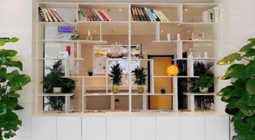 a room with white shelves filled with plants at GreenTree Inn Express Yingtan Yujiang Railway Station in Yingtan