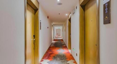 an empty hallway with a colorful floor in a building at Borrman Hotel Huizhou West Lake Shuidong Street in Huizhou