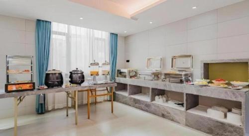 a large kitchen with some food on display at Borrman Hotel Huizhou West Lake Shuidong Street in Huizhou