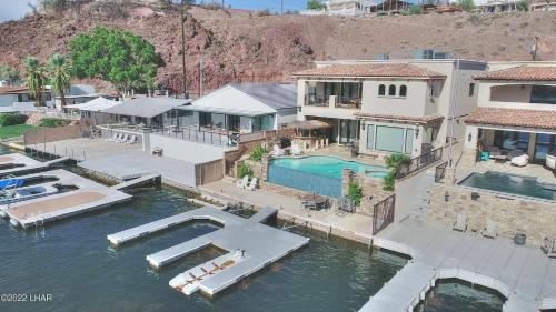 an aerial view of a house with a swimming pool at Splash Landing! Dock, Pool & Hot Tub , Riverfront House & Guest in Cienega Springs