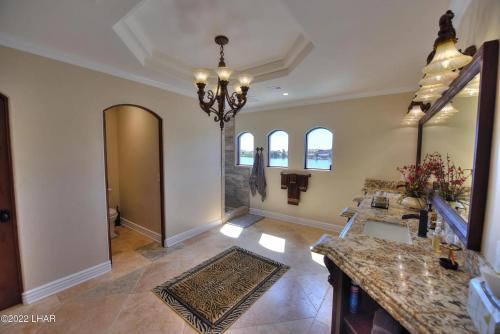 a large hallway with a cross on the wall at Splash Landing! Dock, Pool & Hot Tub , Riverfront House & Guest in Cienega Springs