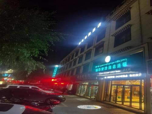 a car parked in front of a building at night at City Comfort Inn Lhasa Potala Palace Scenic View in Lhasa